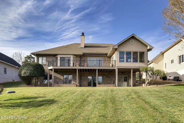 back of house with a yard, central air condition unit, and a wooden deck