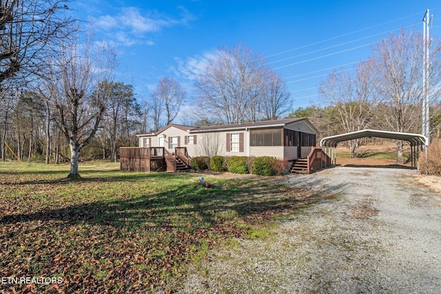 view of front of house featuring a wooden deck, a sunroom, a front yard, and a carport