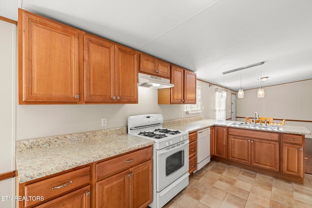 kitchen with light stone countertops, sink, kitchen peninsula, decorative light fixtures, and white appliances