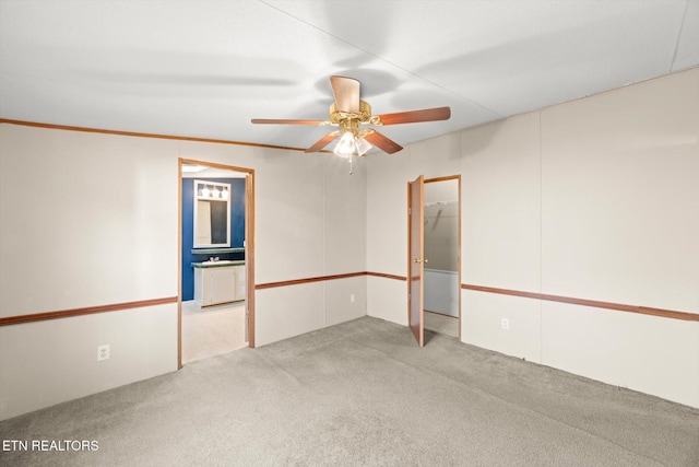 spare room featuring light carpet and ceiling fan