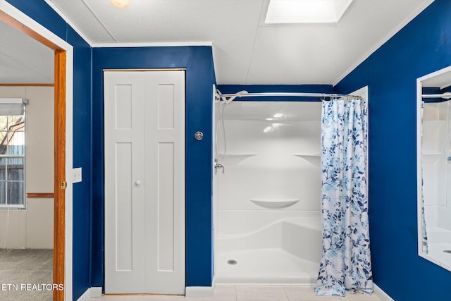 bathroom with a shower with curtain and a skylight