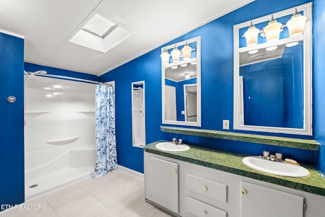 bathroom with tile patterned floors, lofted ceiling with skylight, vanity, and a shower with shower curtain