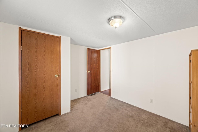 unfurnished bedroom with light colored carpet