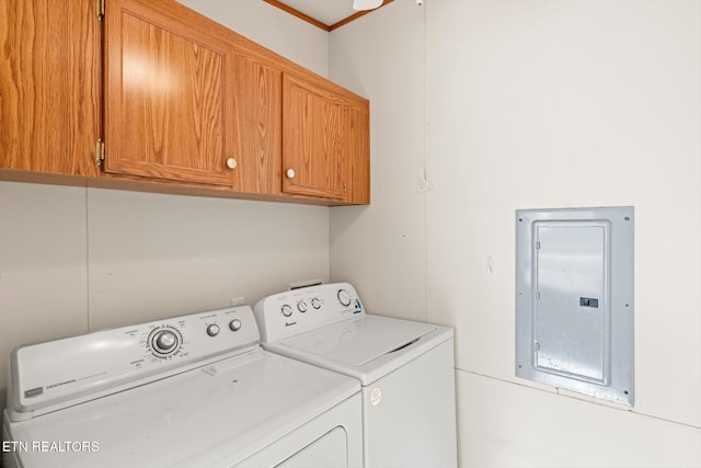 laundry room featuring electric panel, separate washer and dryer, and cabinets