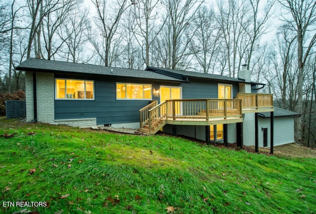 back of house featuring a yard and a wooden deck