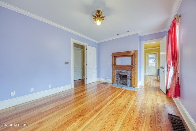 unfurnished living room featuring crown molding and light hardwood / wood-style flooring