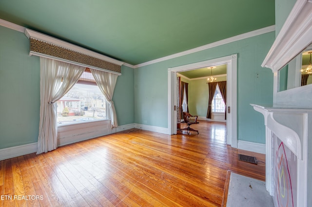 interior space featuring light hardwood / wood-style flooring, a notable chandelier, and ornamental molding