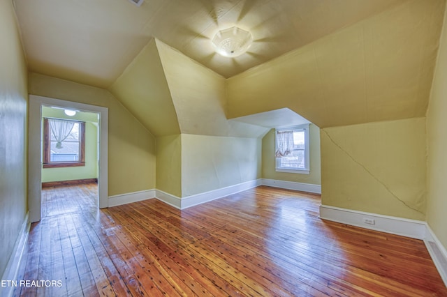 bonus room featuring lofted ceiling and hardwood / wood-style flooring