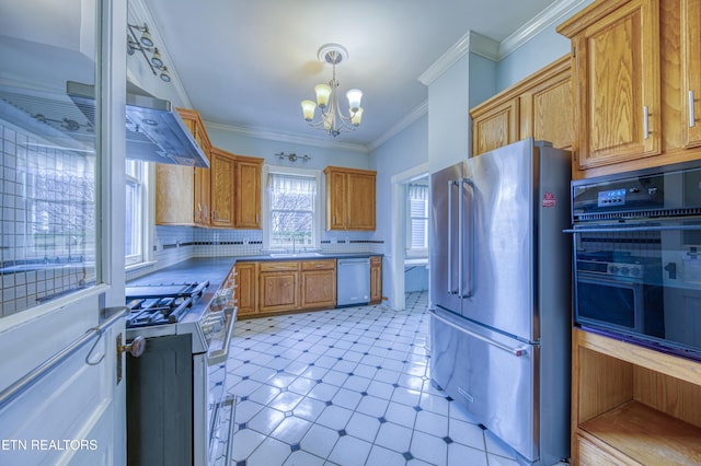 kitchen with stainless steel appliances, a chandelier, decorative light fixtures, decorative backsplash, and ornamental molding