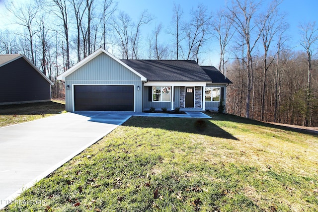 ranch-style home featuring a front yard, a garage, and covered porch