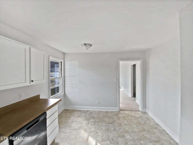 kitchen with dishwashing machine and white cabinetry