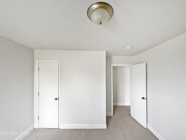 unfurnished bedroom featuring light colored carpet