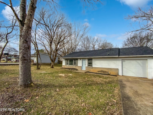 single story home with a front yard and a garage