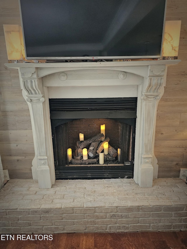 room details with wood walls and a fireplace