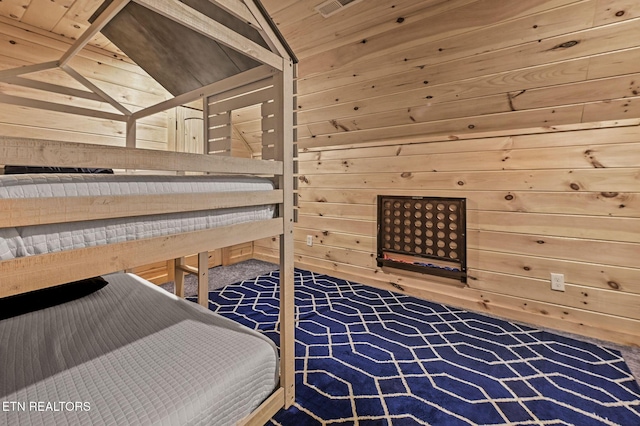 carpeted bedroom featuring wood walls, wood ceiling, and lofted ceiling