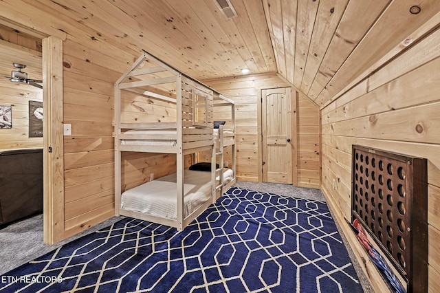 carpeted bedroom with wood walls, wooden ceiling, and vaulted ceiling