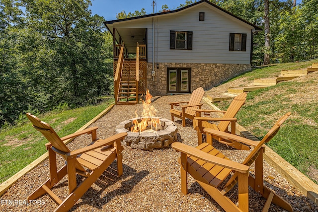 back of property featuring a fire pit