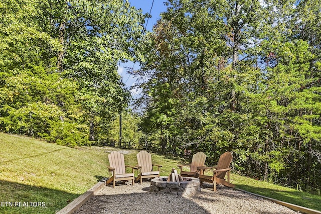 view of yard featuring an outdoor fire pit