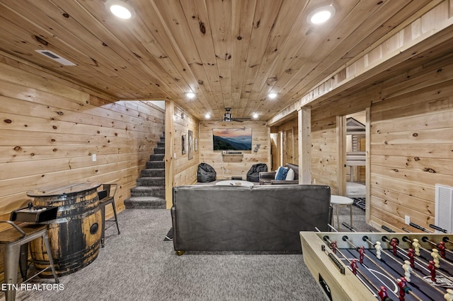 rec room with carpet flooring, wood walls, and wood ceiling