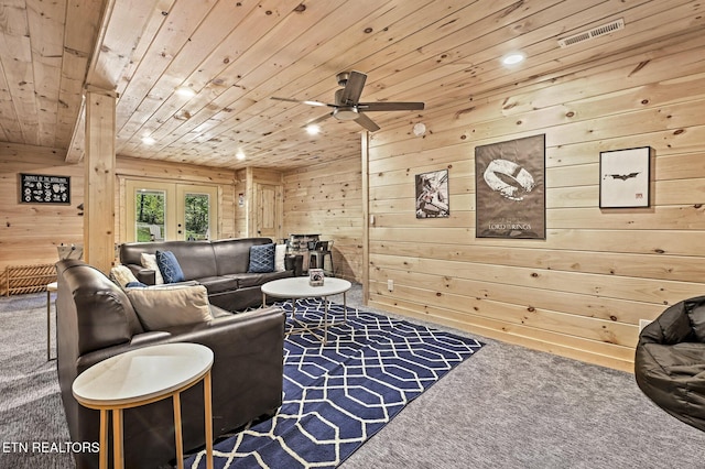 living room with wooden walls, french doors, carpet, and wood ceiling