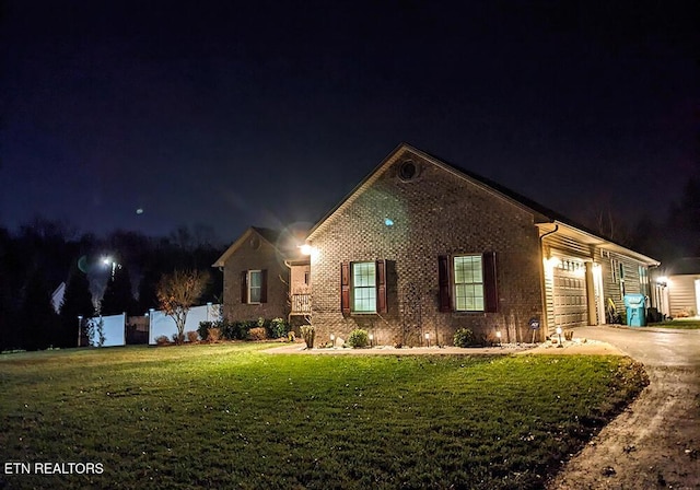 view of front of property with a yard and a garage