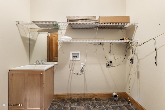 clothes washing area featuring hookup for a washing machine, electric dryer hookup, and sink