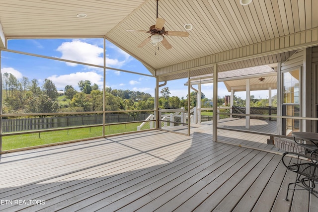 unfurnished sunroom with ceiling fan and lofted ceiling