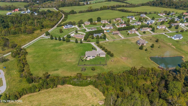 bird's eye view with a water view and a rural view