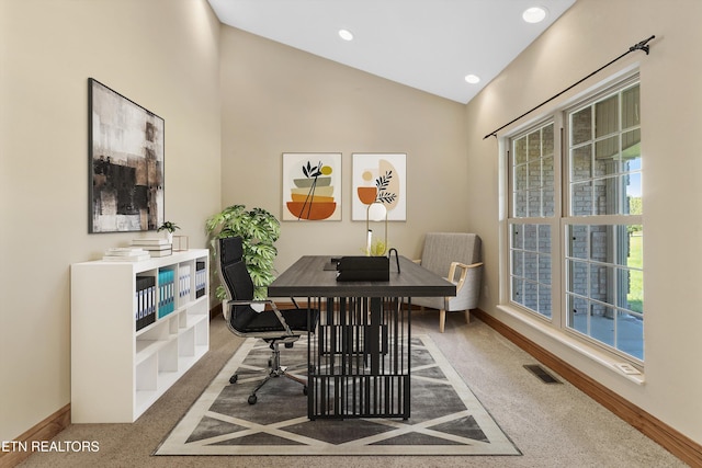 dining room featuring carpet flooring and vaulted ceiling