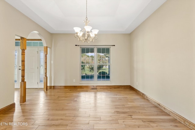 empty room featuring light hardwood / wood-style floors and an inviting chandelier