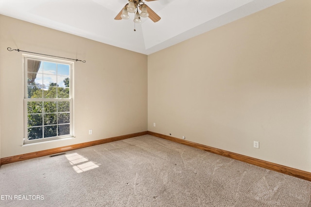 carpeted spare room featuring ceiling fan