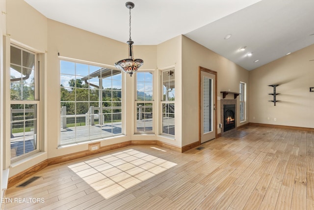 interior space with light wood-type flooring and a notable chandelier