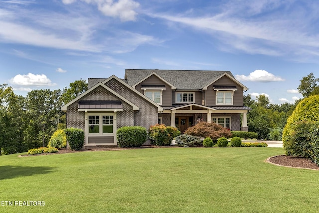 craftsman inspired home featuring a standing seam roof, metal roof, and a front lawn