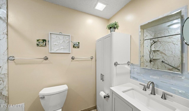 bathroom featuring decorative backsplash, vanity, a textured ceiling, a shower, and toilet