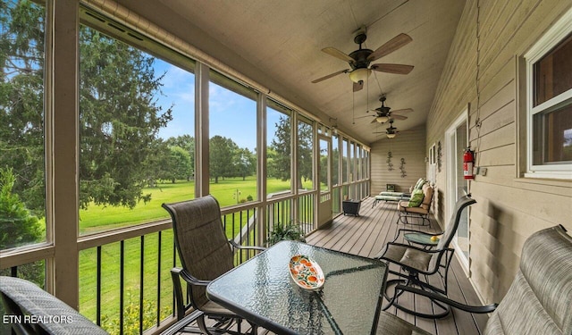 sunroom featuring ceiling fan