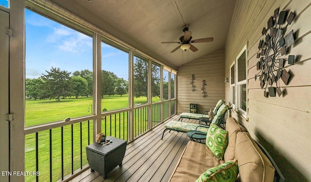 sunroom with ceiling fan and vaulted ceiling