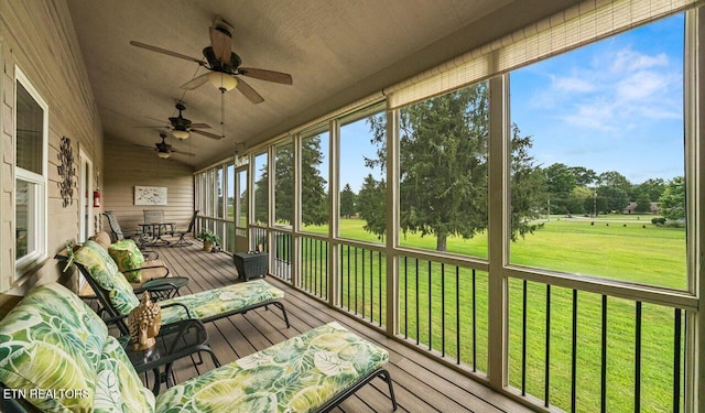 sunroom featuring ceiling fan