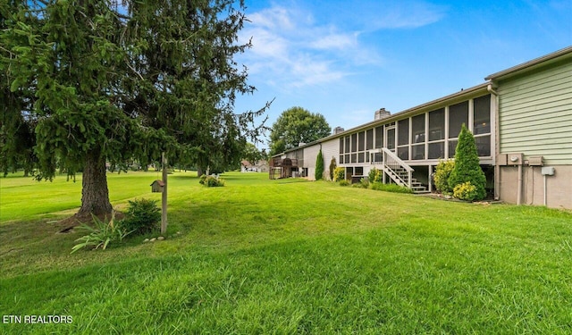 view of yard featuring a sunroom