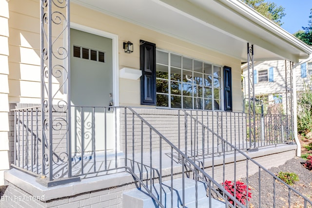 view of exterior entry with a porch