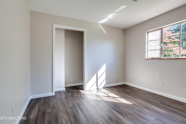 empty room with dark hardwood / wood-style floors