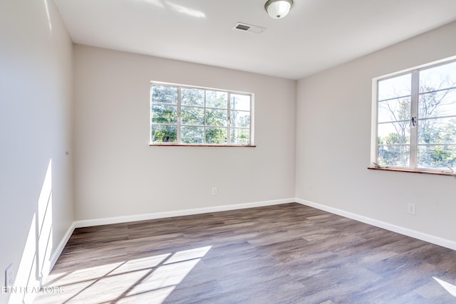 unfurnished room featuring hardwood / wood-style flooring