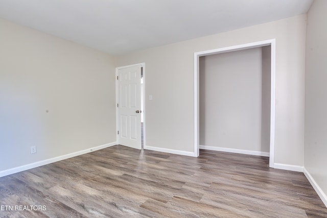 unfurnished bedroom with hardwood / wood-style flooring