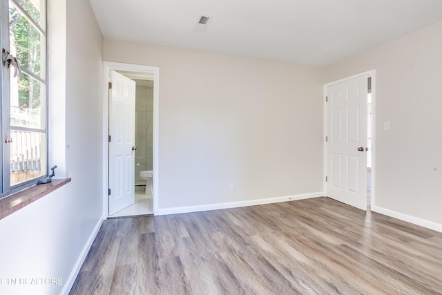 empty room featuring light hardwood / wood-style flooring and a wealth of natural light