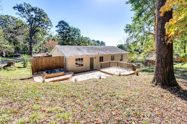 back of house featuring a wooden deck