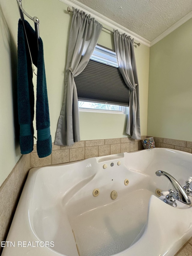 bathroom with a washtub, crown molding, and a textured ceiling