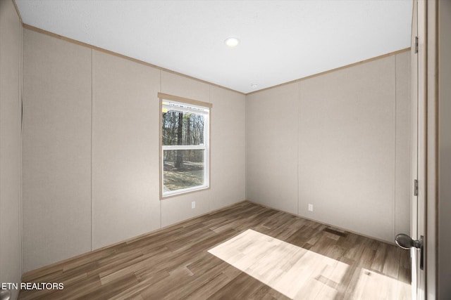 unfurnished room featuring hardwood / wood-style flooring