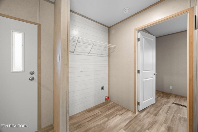 washroom featuring electric dryer hookup and light hardwood / wood-style flooring