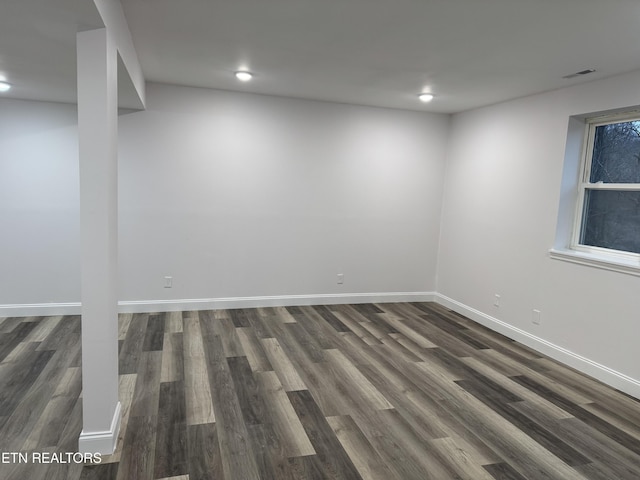 empty room with dark hardwood / wood-style floors