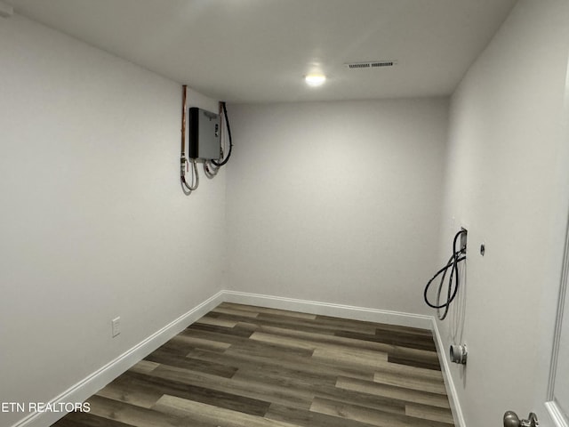 unfurnished room featuring dark wood-type flooring