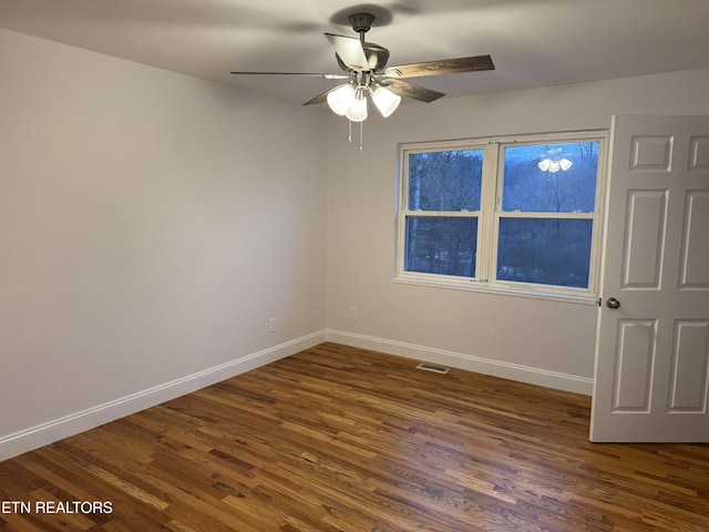 empty room featuring ceiling fan and dark wood-type flooring